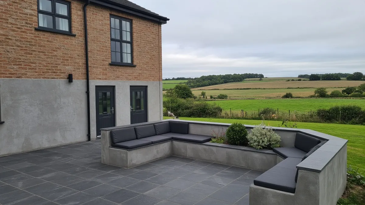 Example image: a charcoal porcelain patio with a seating wall